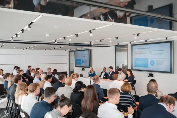 The speakers and audience viewed across the conference room at Goodwin — Management Incentives in the AI Era
