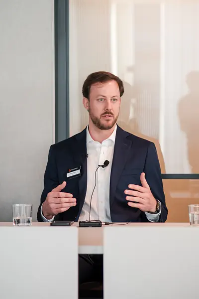 A panel speaker making an animated gesture at Goodwin — Management Incentives in the AI Era