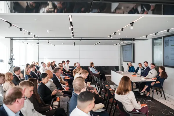The speakers and audience viewed across the conference room at Goodwin — Management Incentives in the AI Era