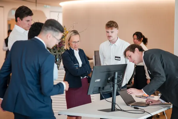 Guests gathered around a demonstration screen at Goodwin — Management Incentives in the AI Era