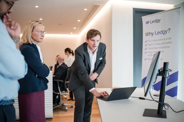 Guests discussing a demonstration screen at Goodwin — Management Incentives in the AI Era