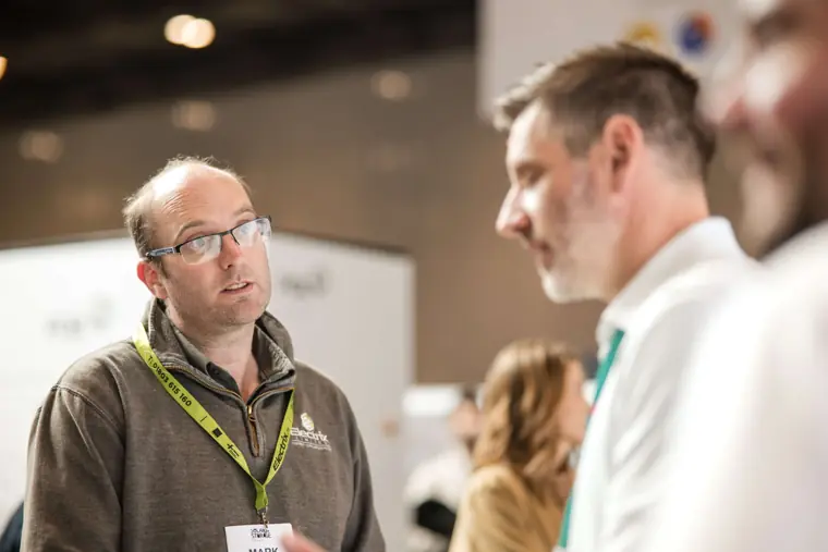 A visitor listening during an exhibition conversation at Fáilte Solar at Solar & Storage