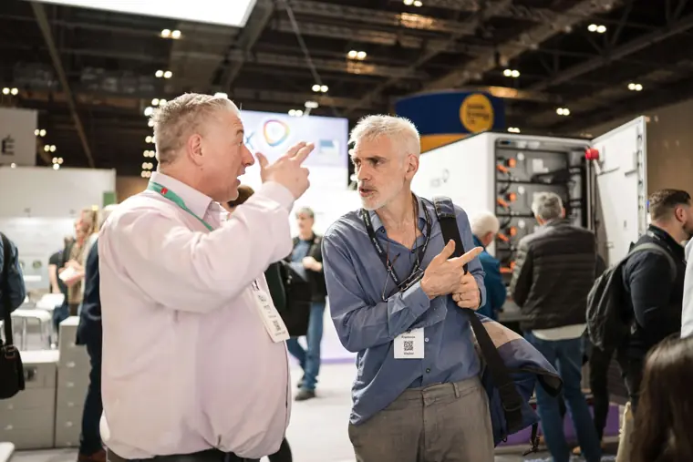 Visitors discussing the technology on display at Fáilte Solar at Solar & Storage