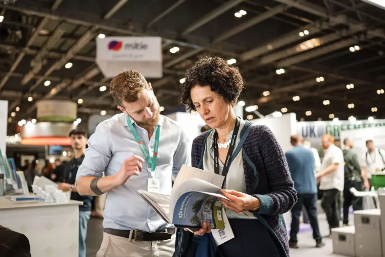A visitor exploring the product literature at Fáilte Solar at Solar & Storage