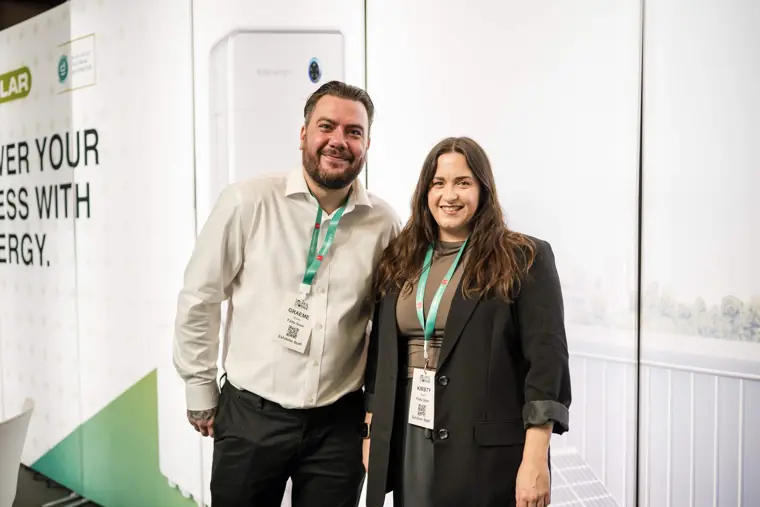 Two attendees pictured at the Fáilte Solar stand at Fáilte Solar at Solar & Storage