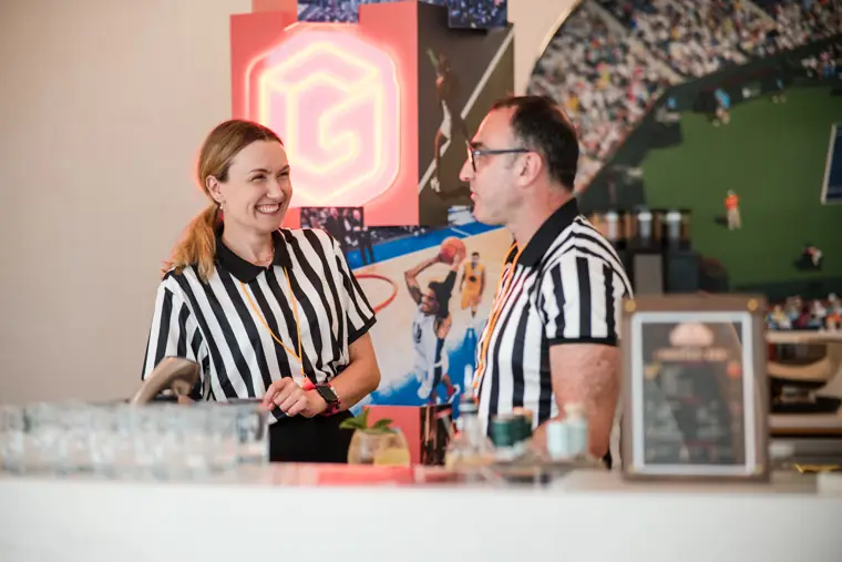 Two bar staff smiling behind the event counter at Goodwin Tavern.