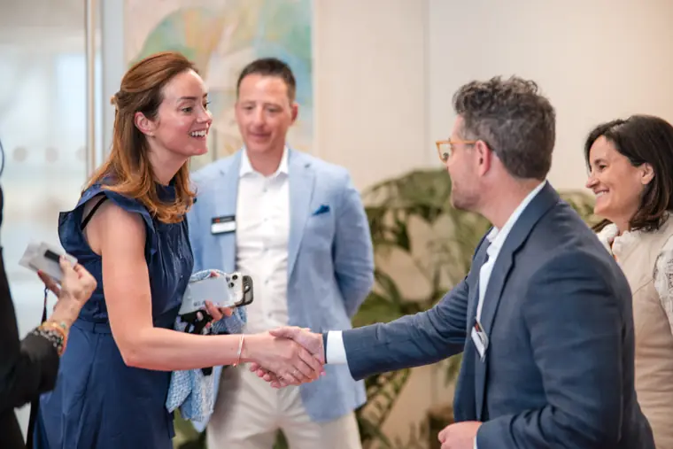 A guest greeting a colleague in the reception room at Goodwin Tavern.