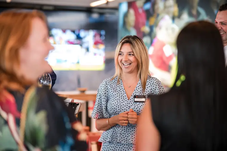 A guest smiling during a conversation at Goodwin Tavern.