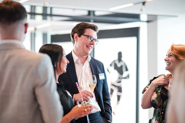 Guests sharing a light moment at the reception at Goodwin Tavern.