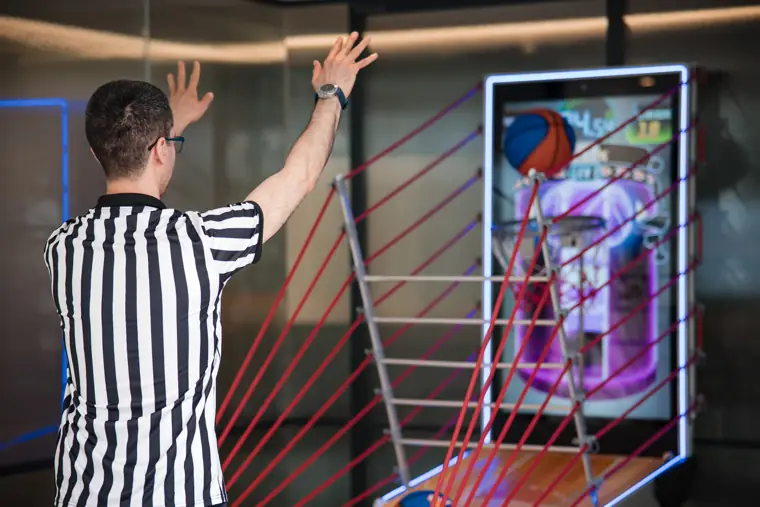 A guest playing the basketball arcade game at Goodwin Tavern.