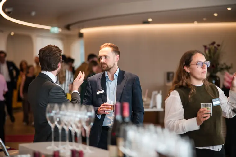 Guests gathering around the drinks counter at Goodwin Tavern.