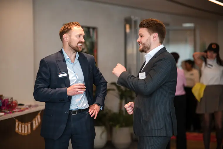 Two colleagues talking in the event room at Goodwin Tavern.