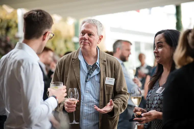 Guests talking in the reception space at Goodwin Tavern.
