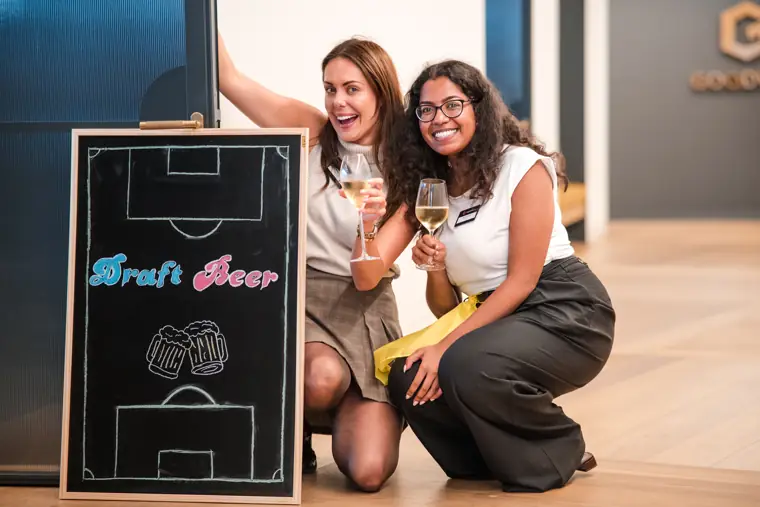 Two guests enjoying the basketball arcade game at Goodwin Tavern.