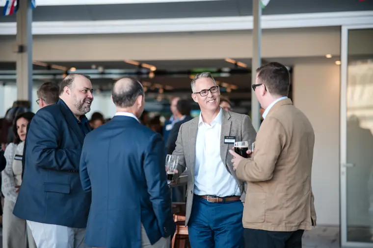 Guests talking in the main event space at Goodwin Tavern.
