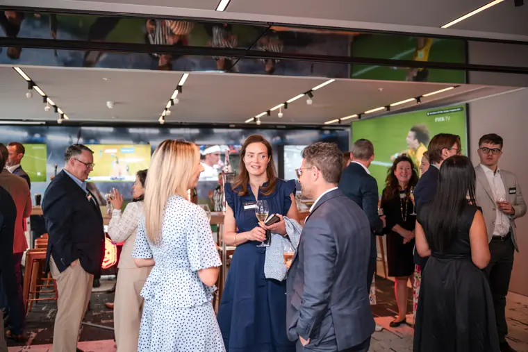 Guests talking beside the sports screens at Goodwin Tavern.