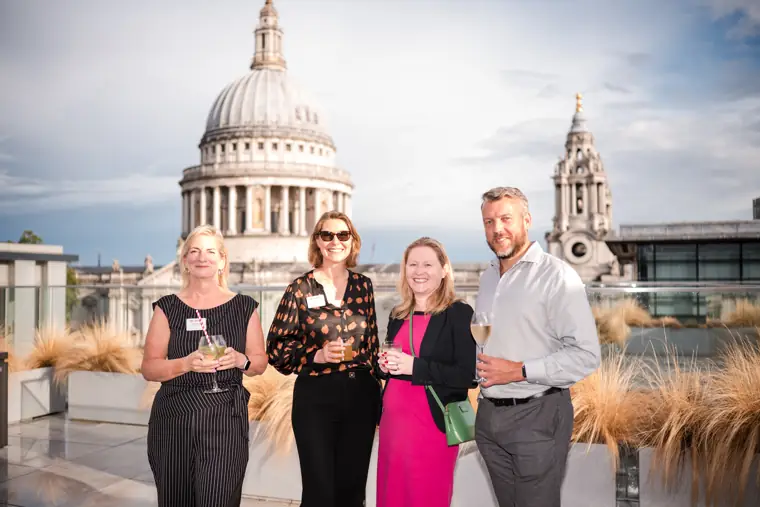 A group portrait against the London skyline at Goodwin Tavern.