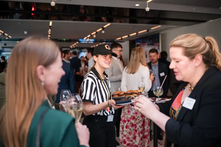 Guests chatting around the food station at Goodwin Tavern.