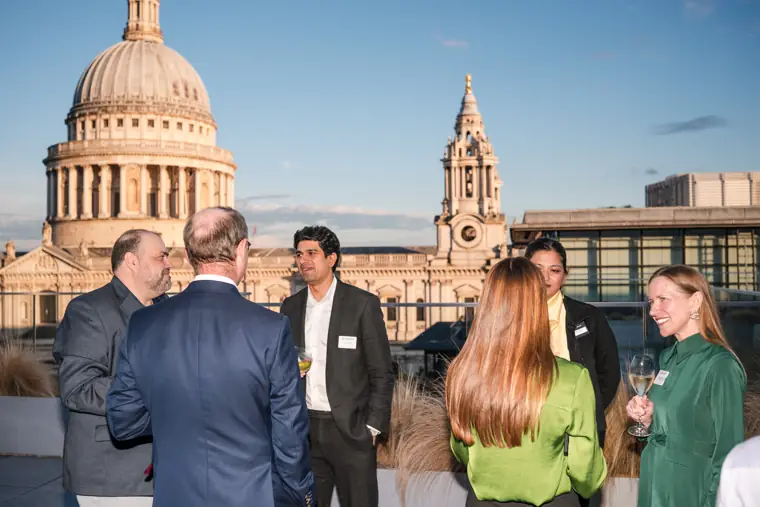 Guests chatting on the terrace with the city backdrop at Goodwin Tavern.