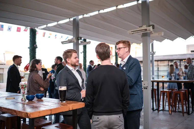 Guests in conversation around a terrace table at Goodwin Tavern.
