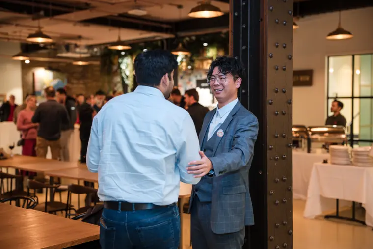 Guests in conversation near the reception desk.