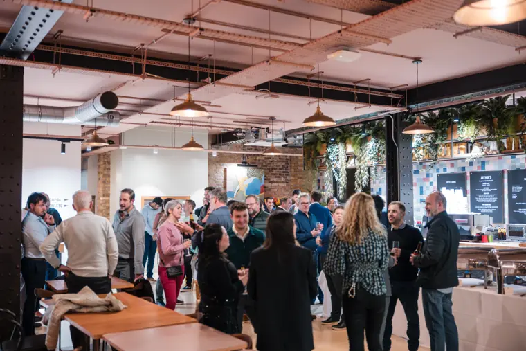 Wide view of guests filling the event space.