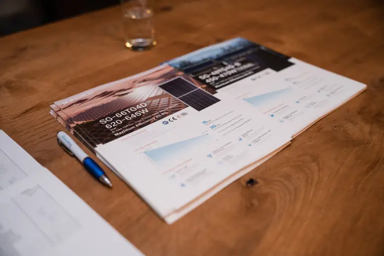 Printed event programme on a reception table.