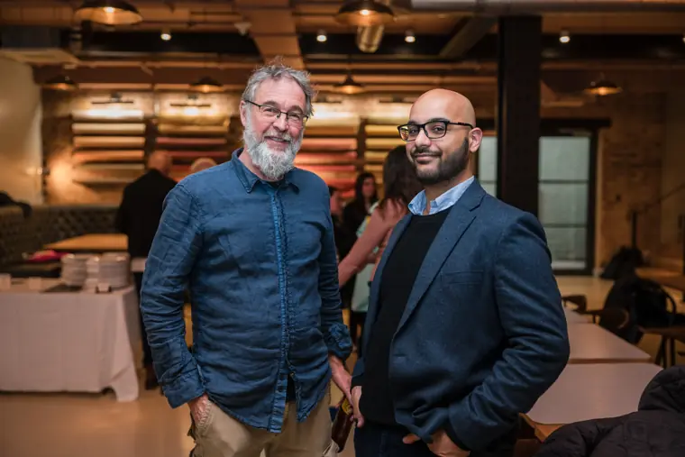Two guests posing together during networking.