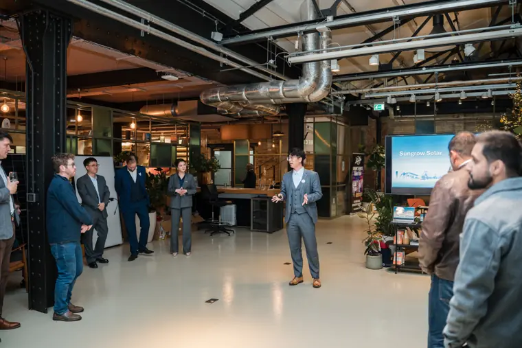 Presenter addressing the audience in the event space.