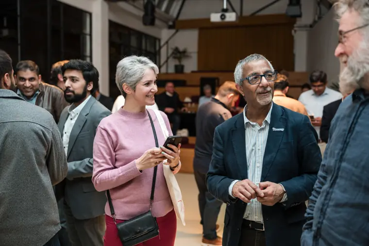 Attendees reconnecting over drinks.