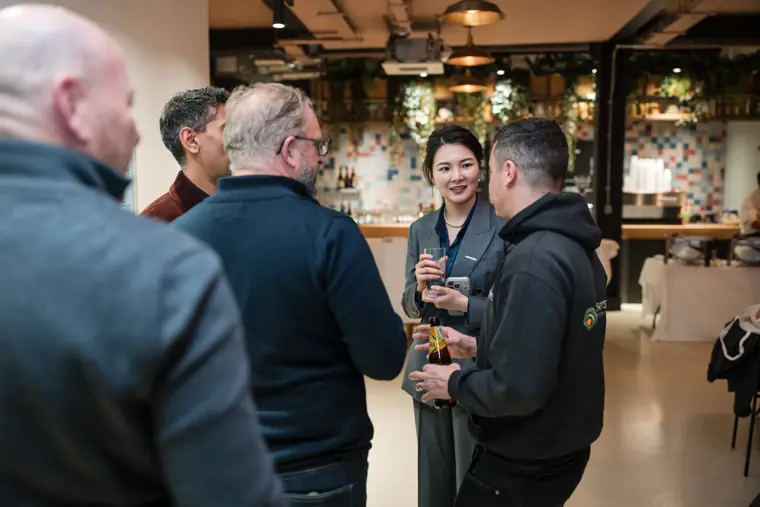 Guests sharing a drink in the reception space.