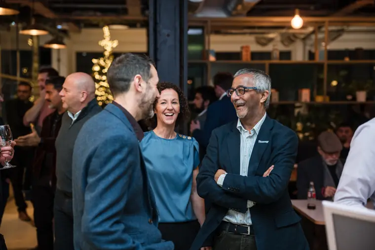 Guests enjoying a conversation over food.