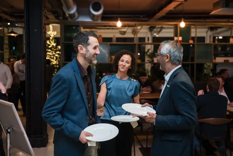 Attendees talking during the meal.