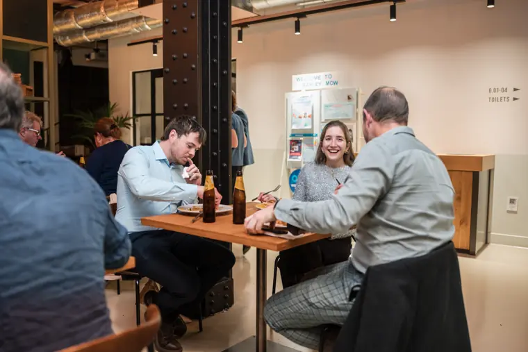 Two guests talking at a small table.