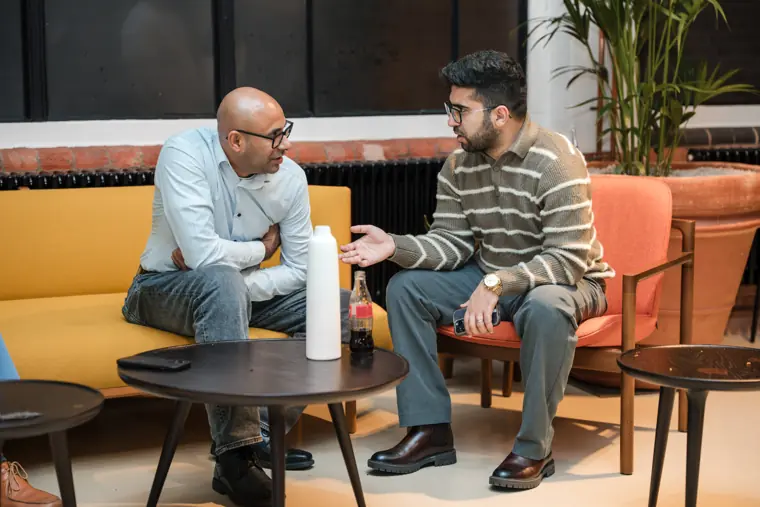 Two colleagues discussing an event display.