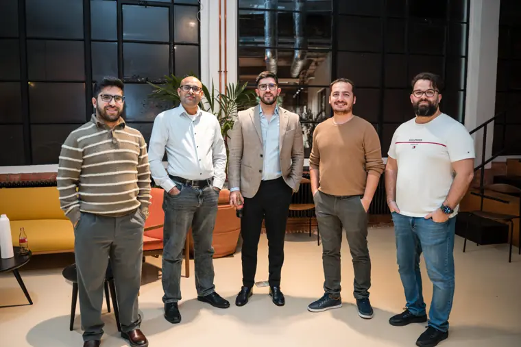 Guests posing beside solar product displays.