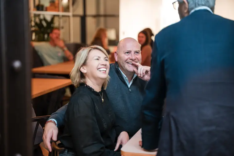 Guests sharing a light moment at the venue.
