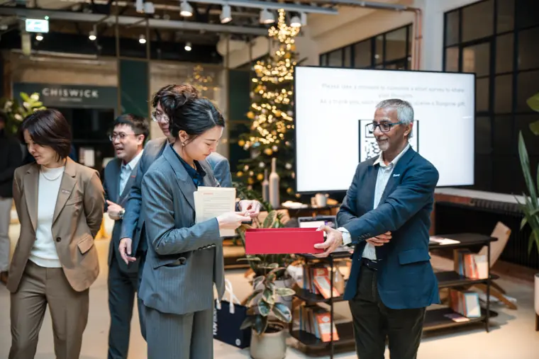 Team presenting a prize to a client.