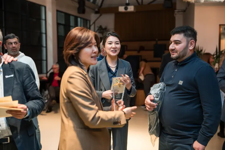 Guests networking near the awards area.