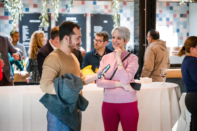 Guests talking near the refreshment station.