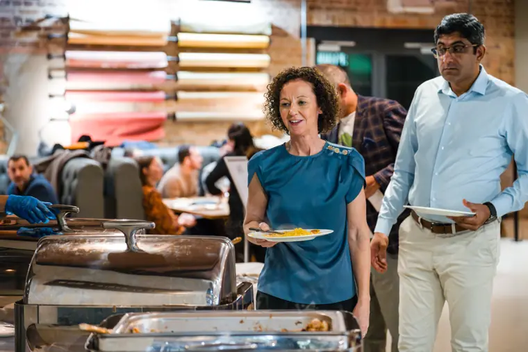 Two attendees pictured beside the buffet.