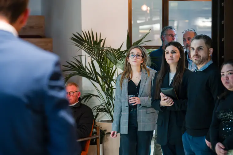 Attendees speaking in the reception area.
