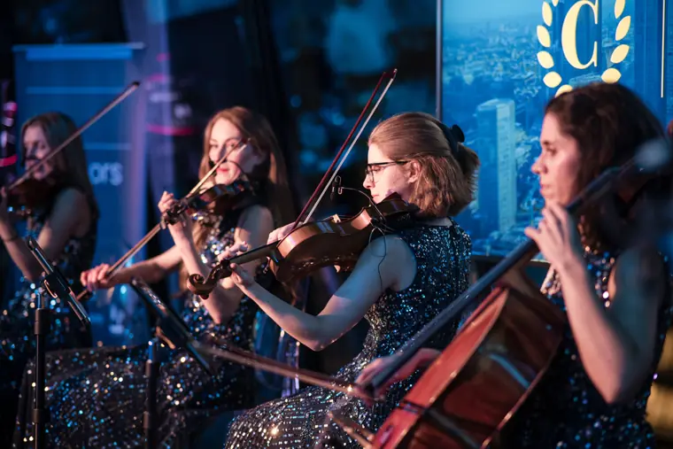 Violinists performing during the reception.