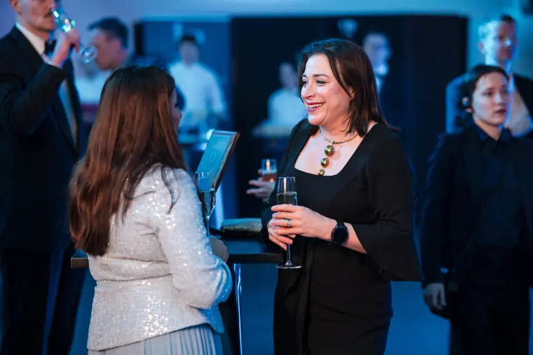 Two guests talking during the welcome reception.