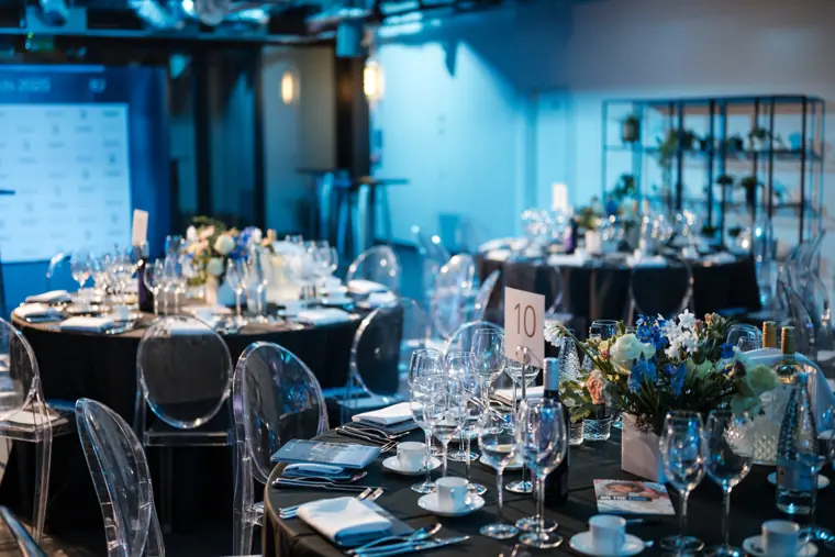 Dinner tables set beneath the city views.