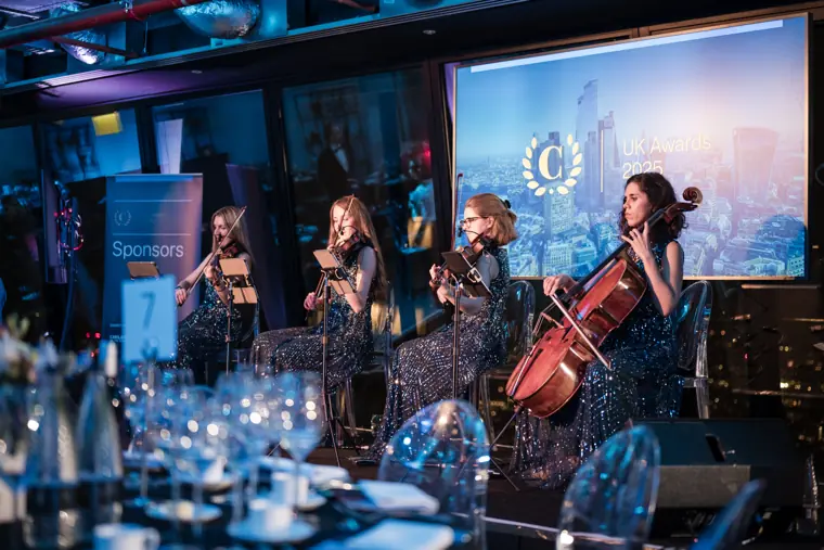 The quartet performing beside the dinner tables.
