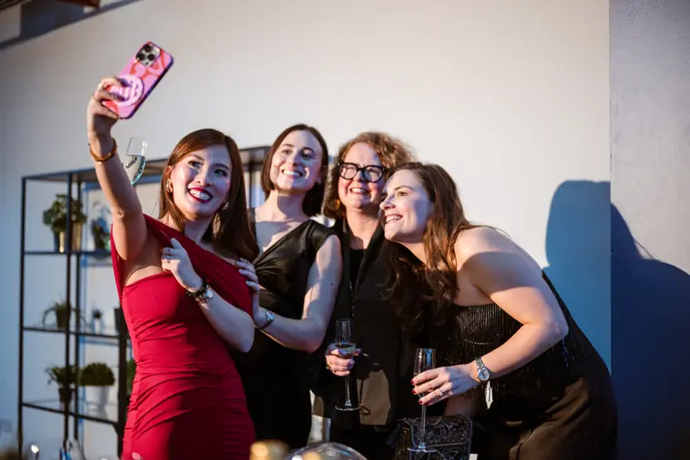 Four guests taking a selfie at the reception.