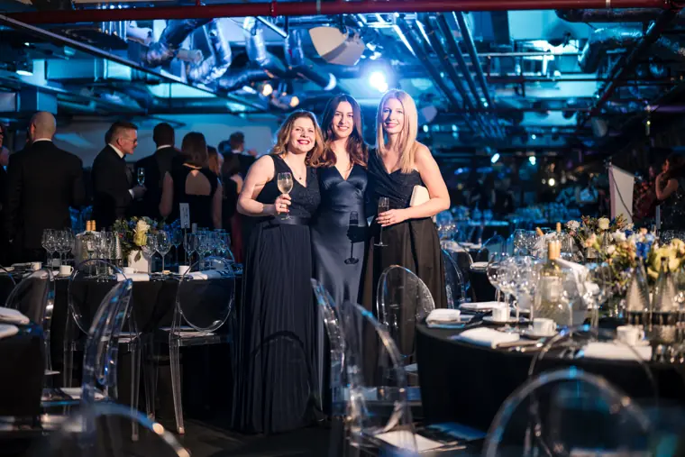 A group of guests posing in the awards hall.