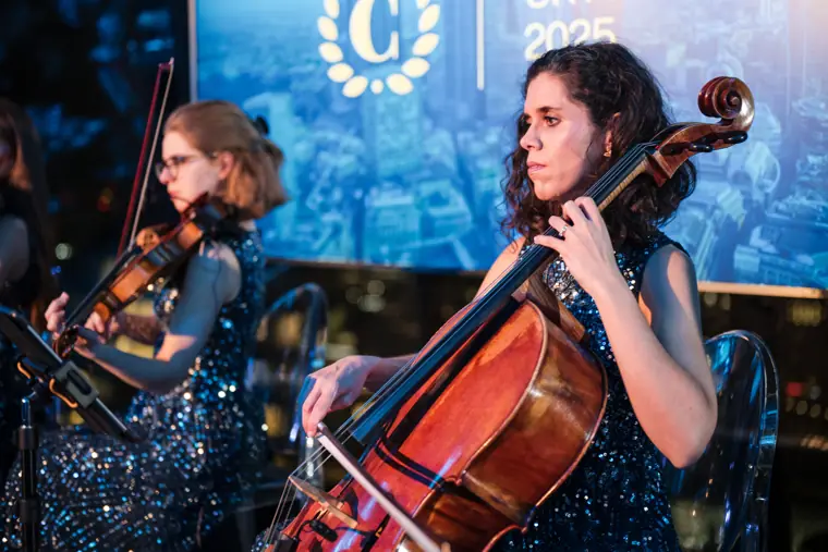 A cellist and violinist playing at the event.
