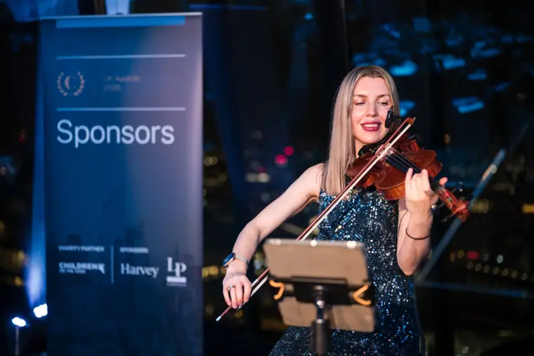 A violinist performing for guests.